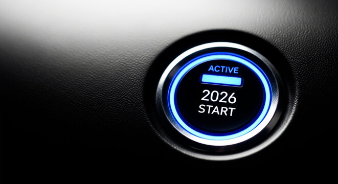 Close up of glowing blue engine start button displaying the year 2026 ready for ignition