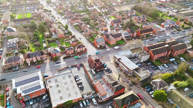 Landscape drone footage panning over the Locks Heath area in Hampshire, South England. A small village near Southampton with a beautiful golden sunset overhead and small suburban houses below