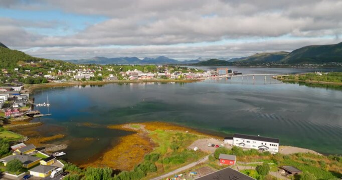 Stokmarknes, Vester&aring;len, Nordland, Norway, with townscape, bridge views, mountains and fjord waters, wide aerial view