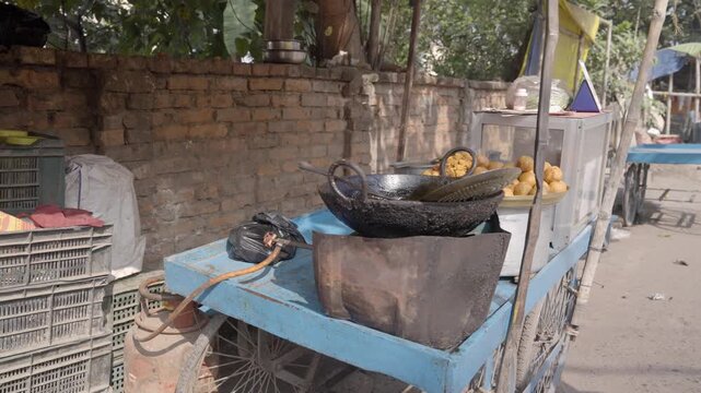 Street food vendor snacks, oil stained utensils at a roadside stall in Bihar, highlighting everyday street food culture, informal economy.