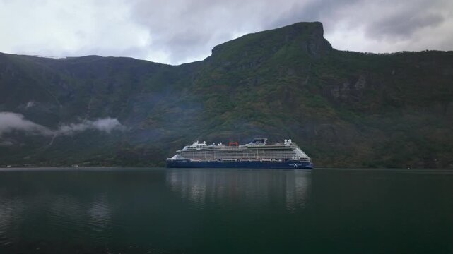 Celebrity Apex Cruise Ship Sailing In Aurlandsfjord With Mountains In The Background In Norway. - wide shot