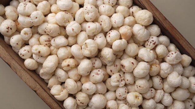 Makhana on wooden tray closeup shot in zoom out motion.
