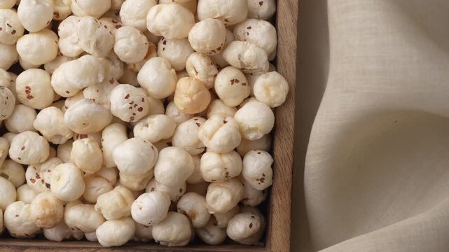 Makhana on wooden tray closeup shot in zoom in motion.