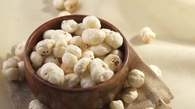 Makhana on wooden bowl closeup shot in zoomin motion.
