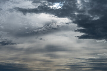 Stormy winter weather sky with patterns of dark and light clouds, as a moody nature background 