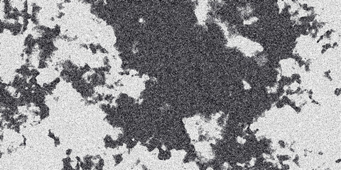 Abstract monochrome textured surface with irregular dark patches and a speckled grainy overlay creating a mottled organic pattern for backgrounds and artistic compositions