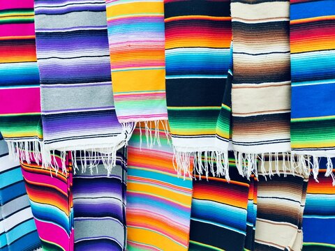 colorful mexican sarapes for sale at the market