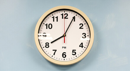 White round wall clock showing 1015 P M on light blue background round clock white clock