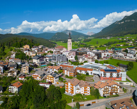 Castelrotto alpine village with church and green valleys in the Dolomites, South Tyrol Italy