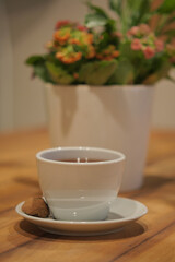Obraz premium Enjoying tea with a cookie on a wooden table