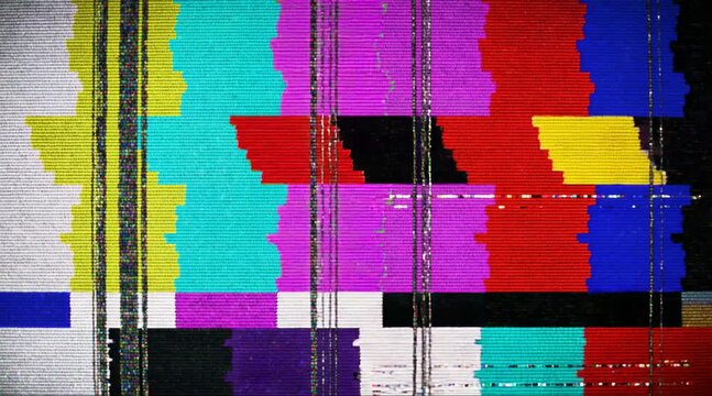 A video screen displays a distorted colorful pattern with static noise