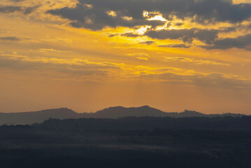 Naklejka premium Clouds in the sunset sky A breathtaking sunset with vivid orange and yellow hues paints the sky