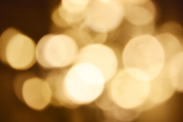 Abstract nature background with dreamy bokeh and soft colorful flower silhouettes in orange and teal.