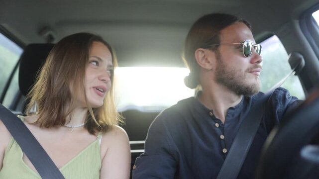 a couple in love are driving in a car and talking