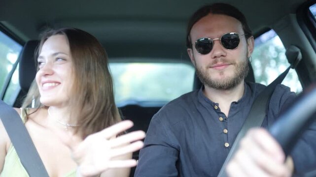 a couple in love are driving in a car and talking