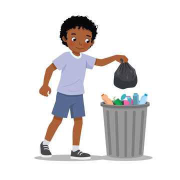 Little African boy throwing trash into recycle bin