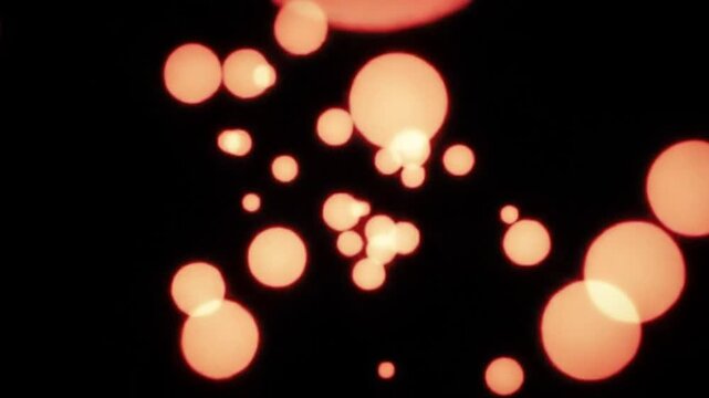 Glowing orange bubbles on black background