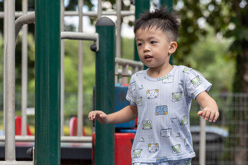 Happy asian boy smiling and playing in playground