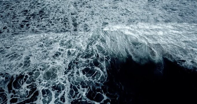 Aerial view Top down aerial view of beautiful giant blue ocean waves crashing and foaming with white wash background. High quality video 4K prores422