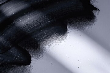 Black powder explosion on gray background with light beam smoke