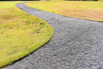 Obraz premium stone path and green grass in the garden