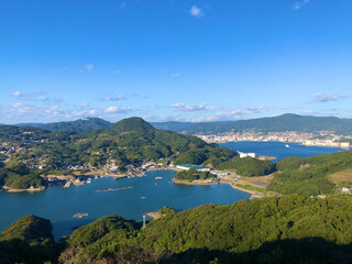 Obraz premium Panoramic view of Kujukushima islands and deep blue sea in Nagasaki. 長崎・九十九島の多島海と深い青色の海が広がるパノラマ風景