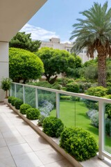 Obraz premium Modern balcony overlooking lush green garden and palm tree