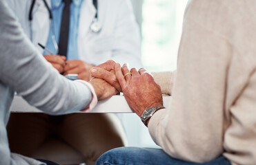 Senior couple, holding hands and consultation with doctor for bad news, medical results and...