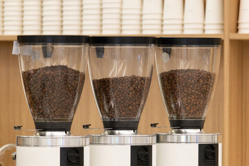 Three coffee grinders are lined up next to each other