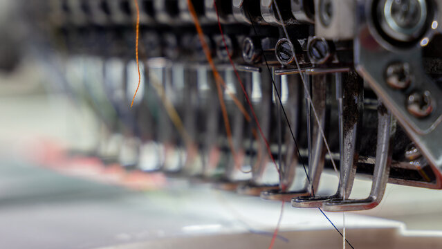 Extreme close-up of Embroidery machine needle in Textile Industry at Garment Manufacturers, Embroidery needle, Needle with thread