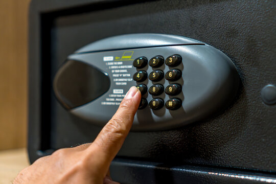 Hand Entering Security Code on Digital Safe Box