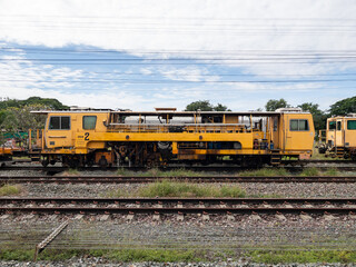 Obraz premium Heavy railway ballast tamping machine for track maintenance.