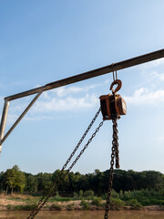 Fototapeta premium Industrial Chain Hoist on Steel Beam at Pier.