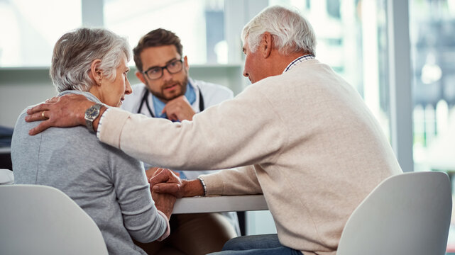 Comfort, senior couple and doctor in consultation, cancer diagnosis and empathy for medical condition. Support, elderly people and physician with bad news for disease, console or compassion in clinic