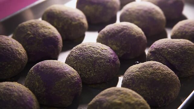 Freshly baked Filipino food called Ube Cheese Pandesal or Bread with yam jam and cheese filling.