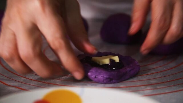 Filipino food called Ube cheese pandesal or bread with yam jam and cheese filling being prepared to be baked.