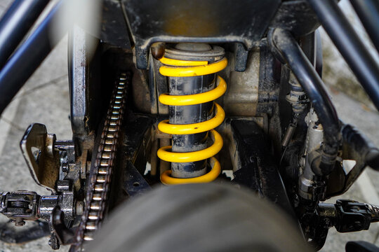 Close Up of Yellow Rear Suspension Spring on Motorcycle