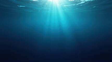 Obraz premium Underwater scene with sunlight filtering through the surface. Deep blue water creates a serene atmosphere. No visible objects or creatures present.