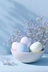 easter eggs in pastel colors and spring flowers inside a bowl on a blue background