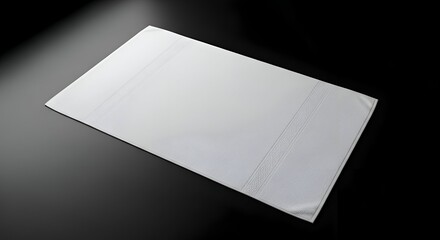 White Cloth On Black Surface With Geometric Pattern and Soft Lighting