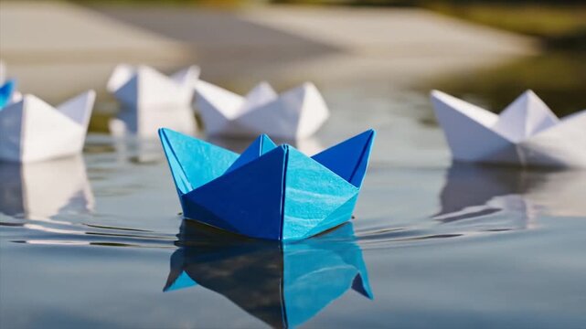 Blue paper boat leads white boats on water surface reflection.