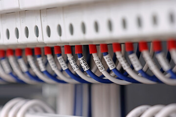 Marking electrical wiring wires with thermally printed nylon tape. 