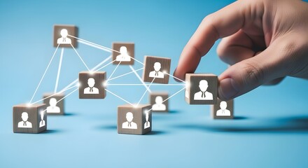 Hand Connecting Wooden Blocks with People Icons