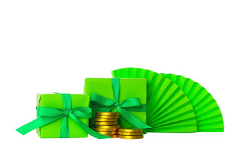 Naklejka premium Two green wrapped gifts and stacks of gold coins, isolated, PNG