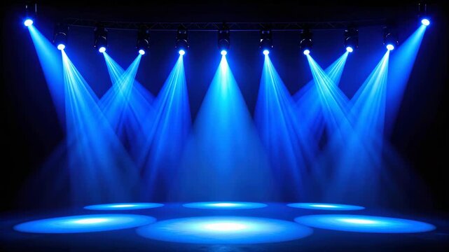 Stage lighting with multiple blue spotlights creating beams on a dark empty performance area