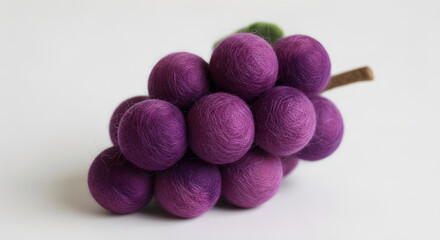 Felted wool grapes bunch on white background.