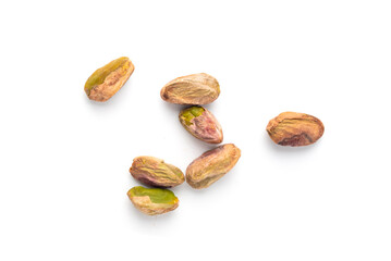 Obraz premium Fried salt pistachio nuts isolated. Baked pistachios pile, roasted green pistache fruits on white