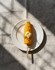 Grilled Corn on the Cob on Stick Minimal Flat Lay Food Photo