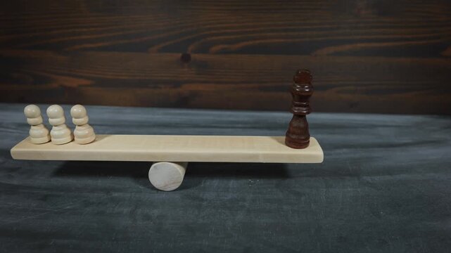 Balance Between Power And People Illustrated With Chess Figures On Wooden Scale