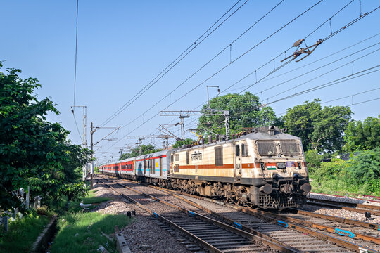Indian Railways express train entering Sawai Madhavpur station under electric overhead lines, Rajasthan, India.